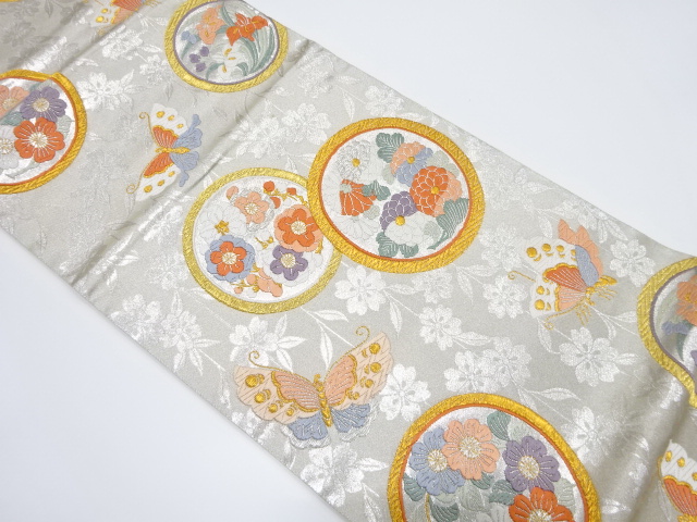 丸紋に蝶模様織り出し袋帯